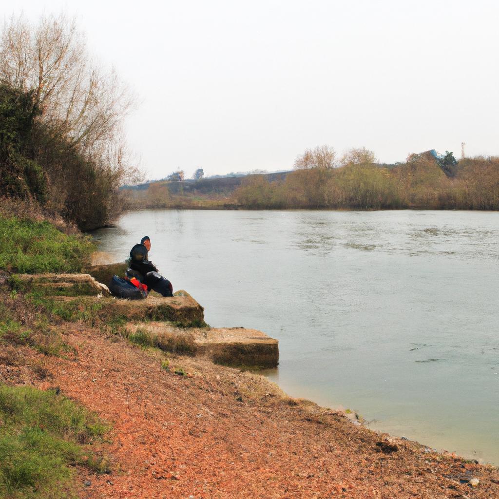 Person fishing by a river