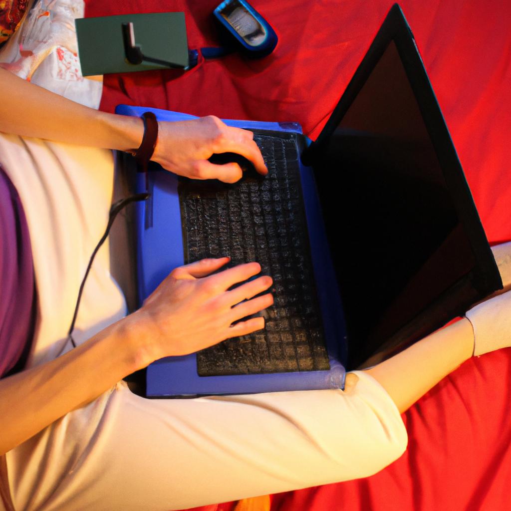 Person using laptop in bedroom